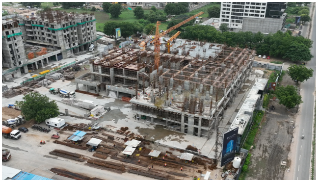 Wide shot of a completed Skrutim Infra high-rise against the skyline, symbolizing the company's long-term vision