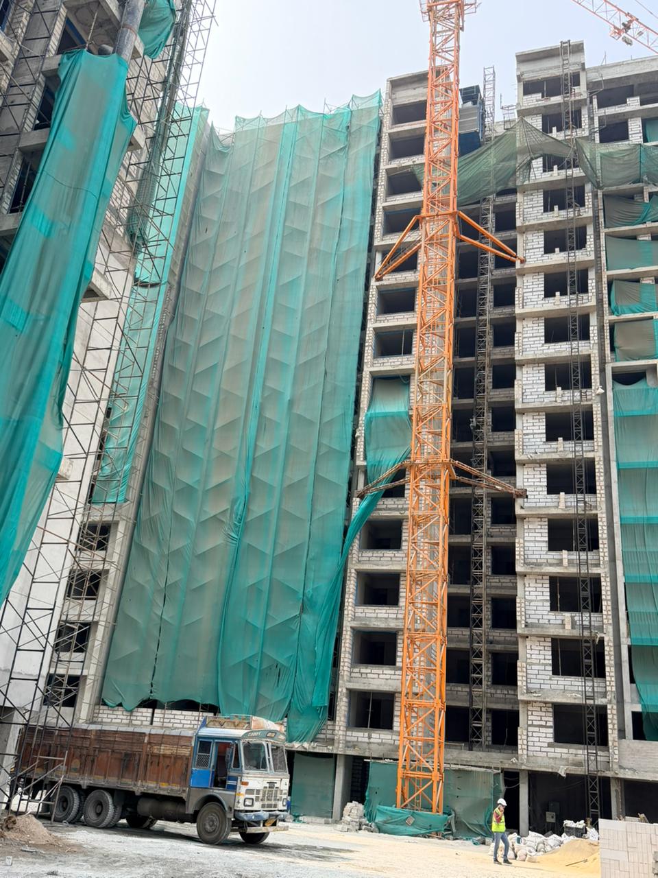 Close-up photo of exposed structural columns and floor slabs mid-construction on a core-and-shell project